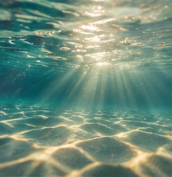 Sunlight beneath clear blue water
